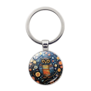 Detailed view of silver owl keychain with artistic glass pendant and colorful floral design