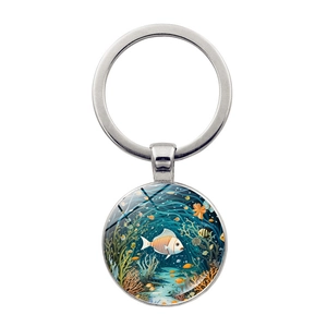 Detailed close-up of a silver keychain pendant featuring a vibrant coral reef illustration