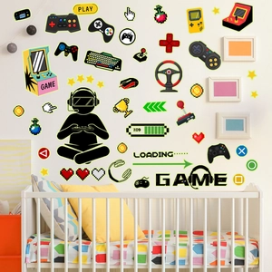 Glow-in-the-dark gaming wall decals featuring controllers and pixel art in a kids room