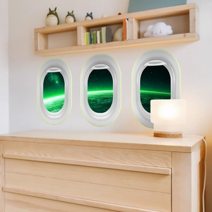 Three creative airplane window wall stickers featuring northern lights and outer space scenes