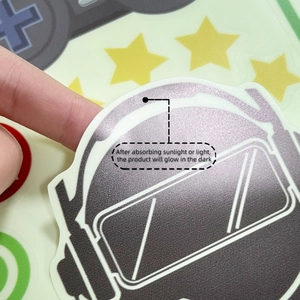 Glow in the dark astronaut helmet wall sticker being peeled off for bedroom decor