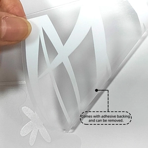 Close-up of peeling white dandelions wall decal showing self-adhesive backing property