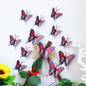 Detail of 12pcs red and black 3D butterfly wall stickers with gold edges on a white wall