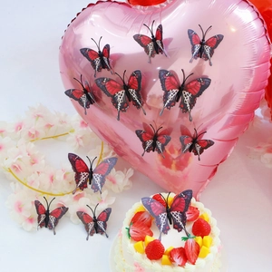 Detailed view of 3D butterfly stickers in red, black and white on a party cake