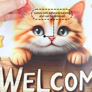 Close-up showing the adhesive backing and removable film of the cat welcome wall sticker