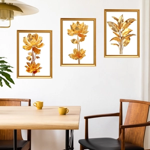 Three-piece gold botanical wall art set with minimalist frames for modern home decor
