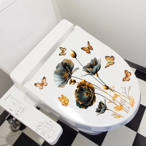 Floral and butterfly self-adhesive wall stickers applied on a white toilet lid in a bathroom