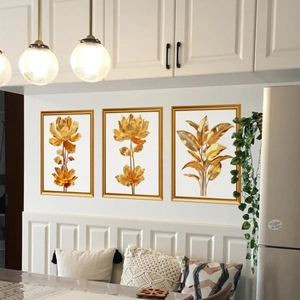 Three-piece gold botanical leaf wall art set with thin metallic frames for home decor