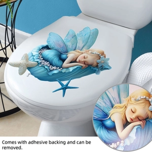 Detail of blue fairy wall sticker showing shell elements and adhesive backing for toilet