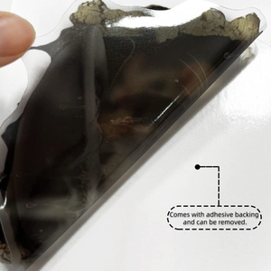 Close-up showing the removable adhesive backing of a cartoon wall sticker application