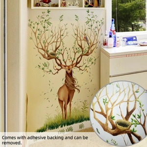 Detail of self-adhesive Nordic elk wall decal with green leaves and bird nest on tree horns