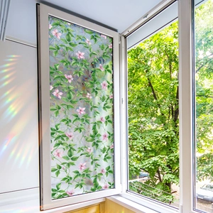 Floral privacy window film with colorful sunlight refraction on white window frame