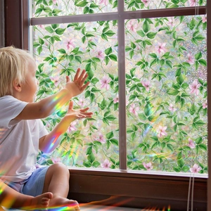 Floral window privacy film showing rainbow light effect on a child in a cozy room