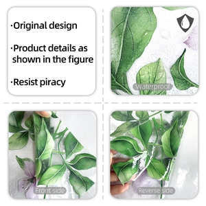 Detail of floral window film showing double-sided design with green leaves and purple flowers