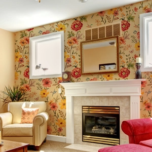 Floral wall mural with red and orange blossoms in a cozy living room setting