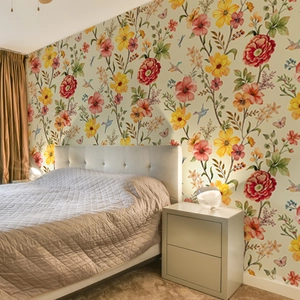 Detailed view of floral wallpaper with birds and butterflies in a warm bedroom setting