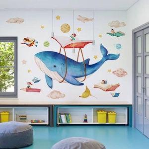 Detail of blue whale and stars wall decals in a bright children bedroom setting
