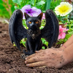Gothic black winged cat garden stake decoration with skull collar in outdoor scene