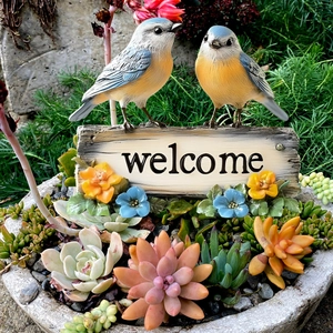 PVC welcome garden stake featuring two blue birds and flowers in a succulent planter