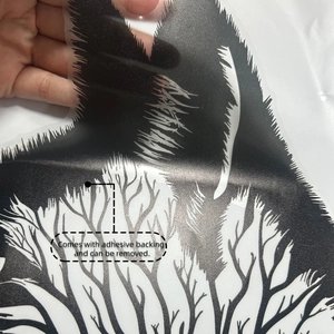 Detail of cat silhouette wall sticker showing branch pattern and adhesive backing