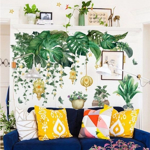 Tropical monstera leaf wall decal with hanging gold lanterns and stars for living room decor