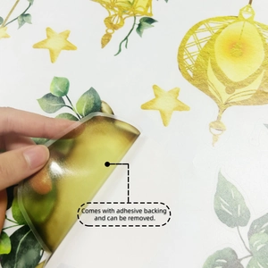 Close-up showing the adhesive backing and easy removal of the star and vine wall sticker