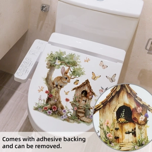 Detailed view of self-adhesive Easter bunny stickers applied on a white toilet lid