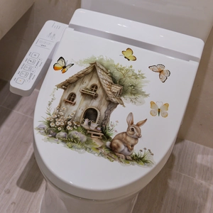 Detail of watercolor Easter bunny and flower decals applied on a white toilet lid