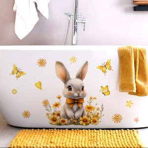 Close-up of cute bunny with yellow bow and flower decals on a white bathtub side