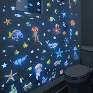 Luminous ocean animal wall stickers with whale and jellyfish glowing in dark bathroom