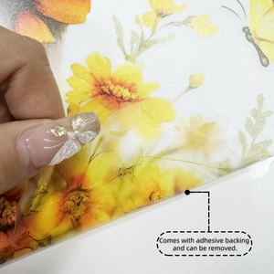 Detailed macro view showing the easy removal of a floral sunflower PET sticker from backing