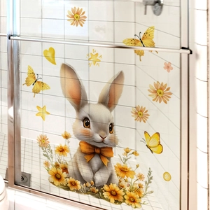 Detail of cartoon Easter bunny and floral decals on a clean bathroom glass door