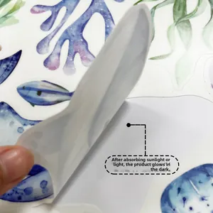 Glow-in-the-dark marine wall decals featuring fish and coral being peeled from backing