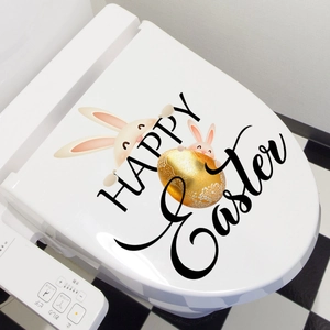 Close-up of Happy Easter toilet lid stickers with cute bunnies and golden egg design