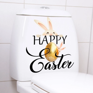 Detailed view of Easter rabbit decals and gold egg sticker on white toilet tank