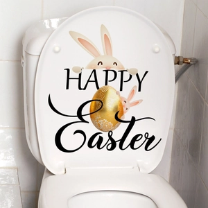 Detail of Happy Easter toilet sticker with cartoon bunnies and golden egg on white lid