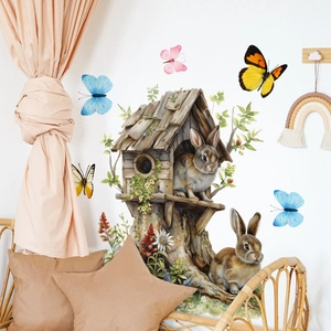 Detail of Easter bunny and tree house wall decals in a cozy nursery room setting