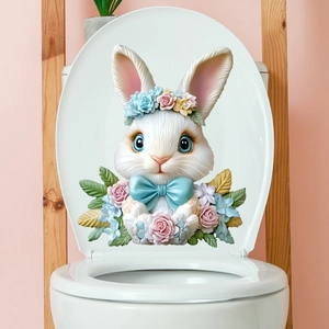 Detail of 3D Easter bunny toilet sticker with floral wreath and blue bow on white lid