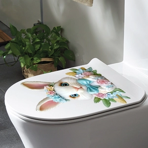 Easter bunny toilet sticker with floral wreath and blue bow on white toilet lid