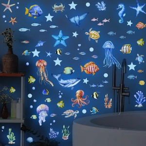Luminous ocean creature wall stickers with whales and stars on deep blue bathroom wall