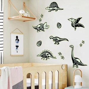 Luminous dinosaur skeleton wall decals featuring footprints and eggs for nursery decor