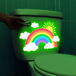 Luminous rainbow and clouds toilet sticker glowing in dark bathroom environment