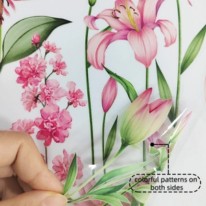 Close-up of pink lily window sticker showing double-sided colorful floral patterns