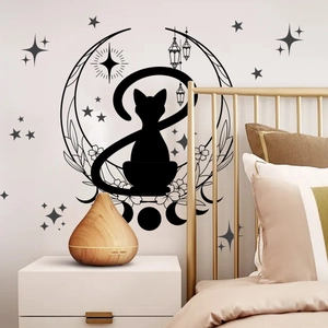 Detail of black cat and moon phase wall sticker in a cozy bedroom setting