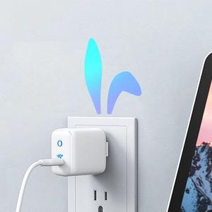 Minimalist white USB wall charger with IQ technology plugged into an outlet with cable