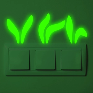Glow-in-the-dark luminous leaf stickers on a three-button wall light switch plate