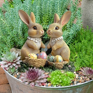 Easter bunny garden stakes with colorful egg baskets in a succulent planter pot