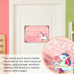 Detail of princess unicorn door sign showing raised grain texture on metal surface