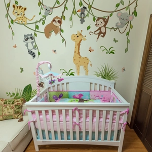 Cartoon jungle animals wall decals with giraffes and monkeys for a cozy baby nursery room
