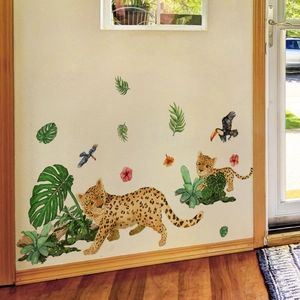 Detailed close-up of jungle wall stickers with leopards and tropical plants in a room